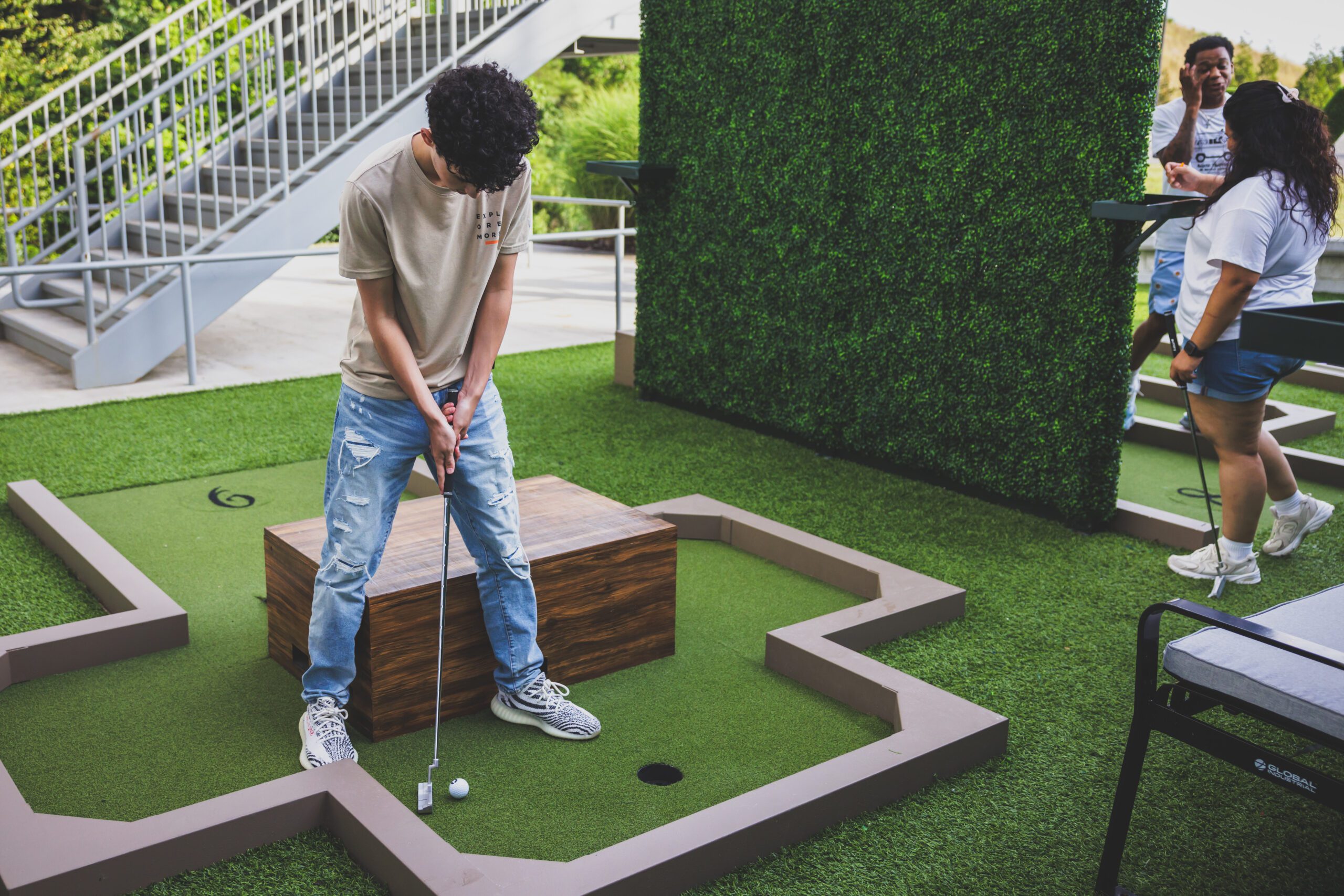 An enchanting kinetic sculpture interacts whimsically with the natural elements of the Art Garden Mini Golf Course, enhancing the game with art.