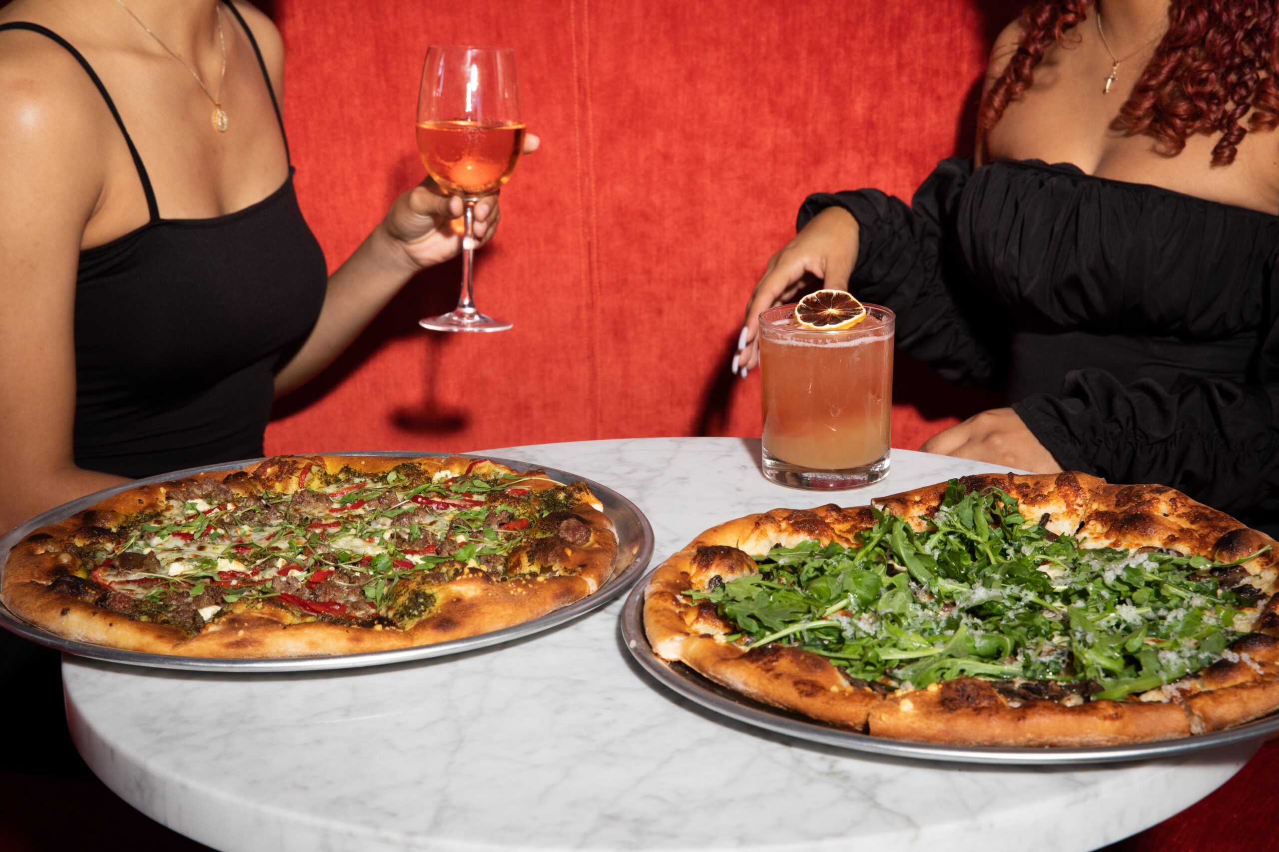 http://two%20women%20enjoying%20cocktails%20and%20scratch%20made%20pizzas%20inside%20Puttery.